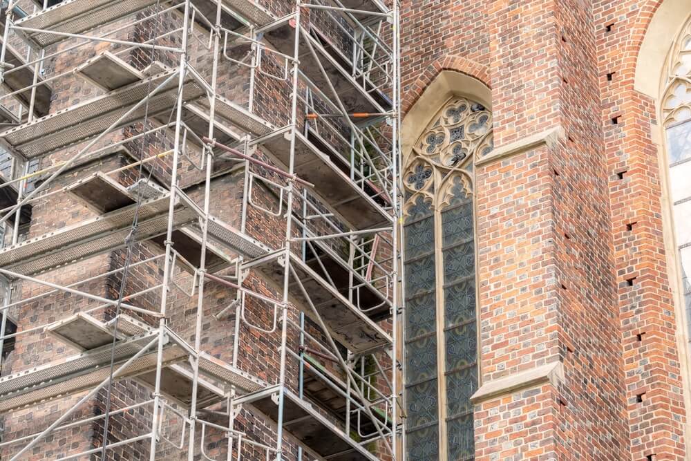 Metal,Scaffolding,Near,A,Gothic,Cathedral,,Church,,Old,Antique,Buildings