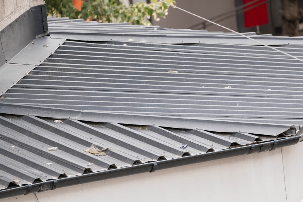 This,Image,Shows,A,Damaged,Corrugated,Metal,Roof,On,A
